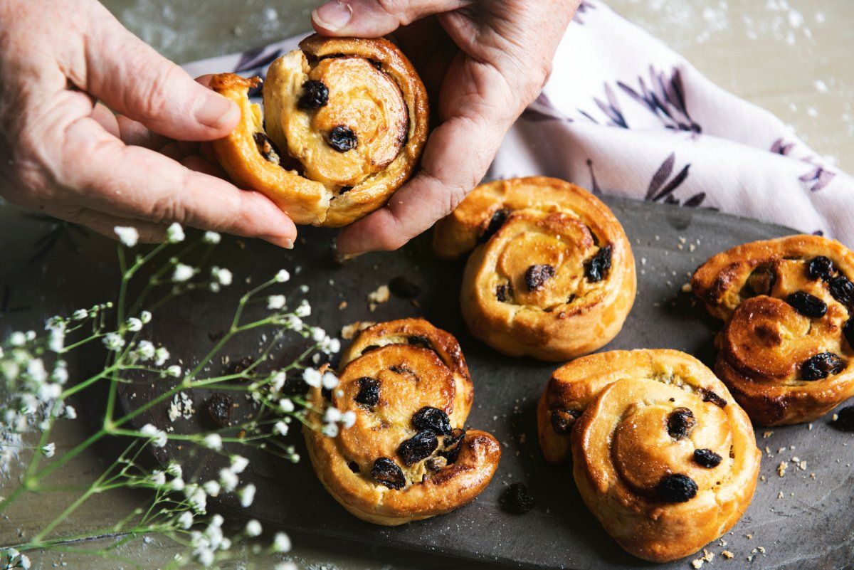 Brioche aux raisins dor&eacute;e pos&eacute;es sur une ardoise.