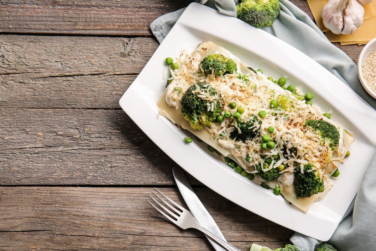 Lasagnes recouvertes de brocoli et petits pois, gratin&eacute;es au fromage.