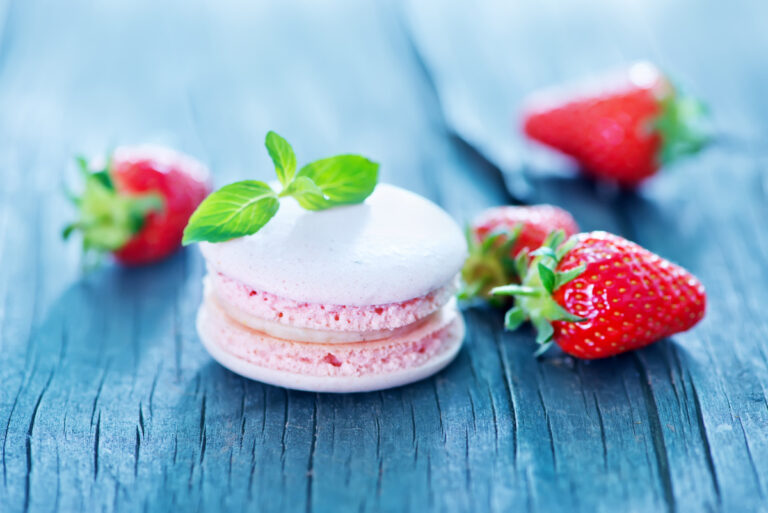 Macaron rose à la fraise décoré de menthe.