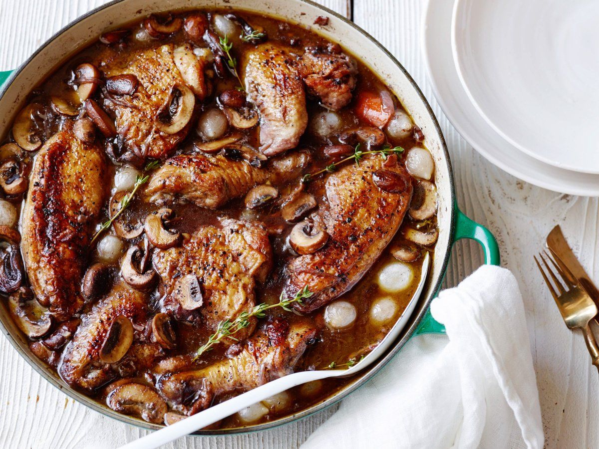 Poulet au vin mijot&eacute; en cocotte avec champignons et oignons.