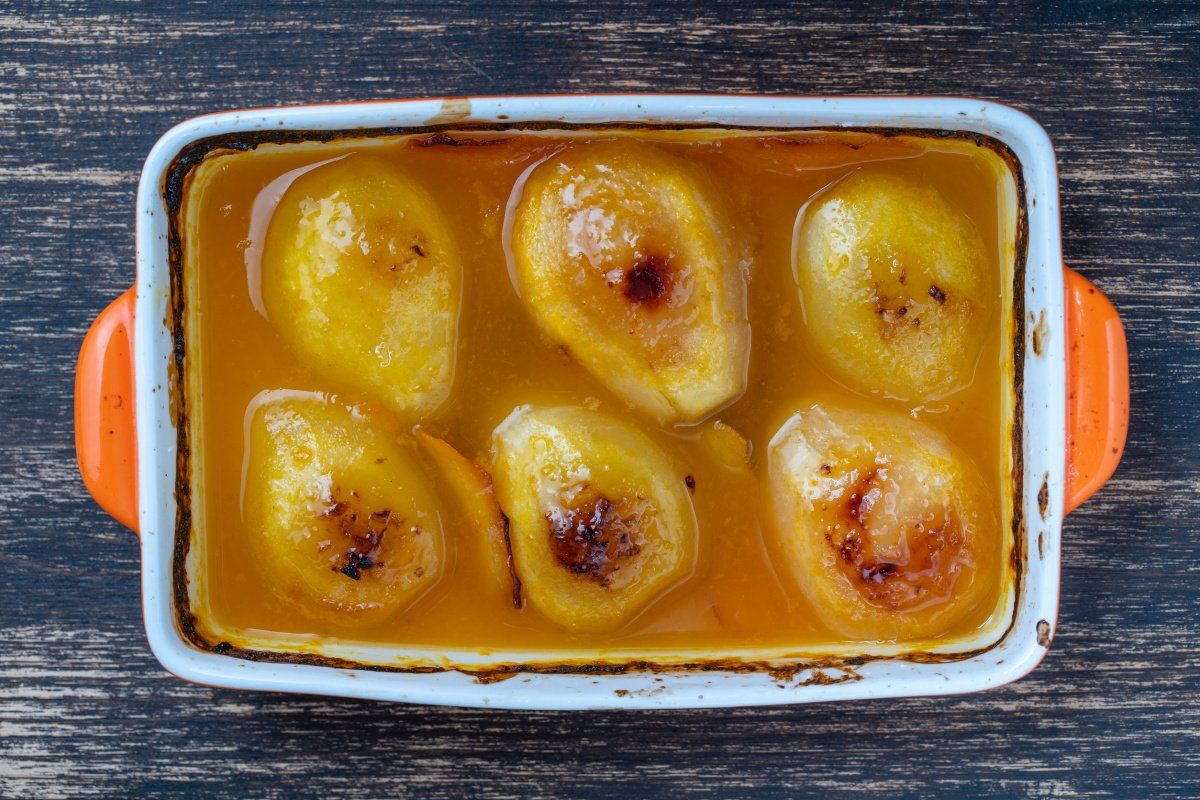 Poires r&ocirc;ties au jus d'orange dans un plat &agrave; gratin.