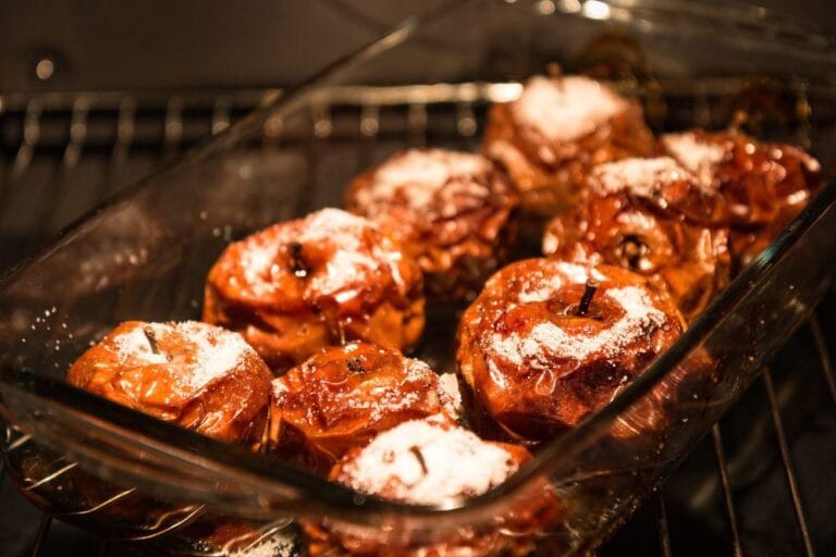 Pommes entières cuites au four, caramélisées et saupoudrées de sucre.